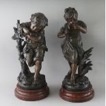 AFTER AUGUSTE MOREAU A GOOD PAIR OF BRONZED SPELTER FIGURES OF A YOUNG BOY AND GIRL. Signed, on