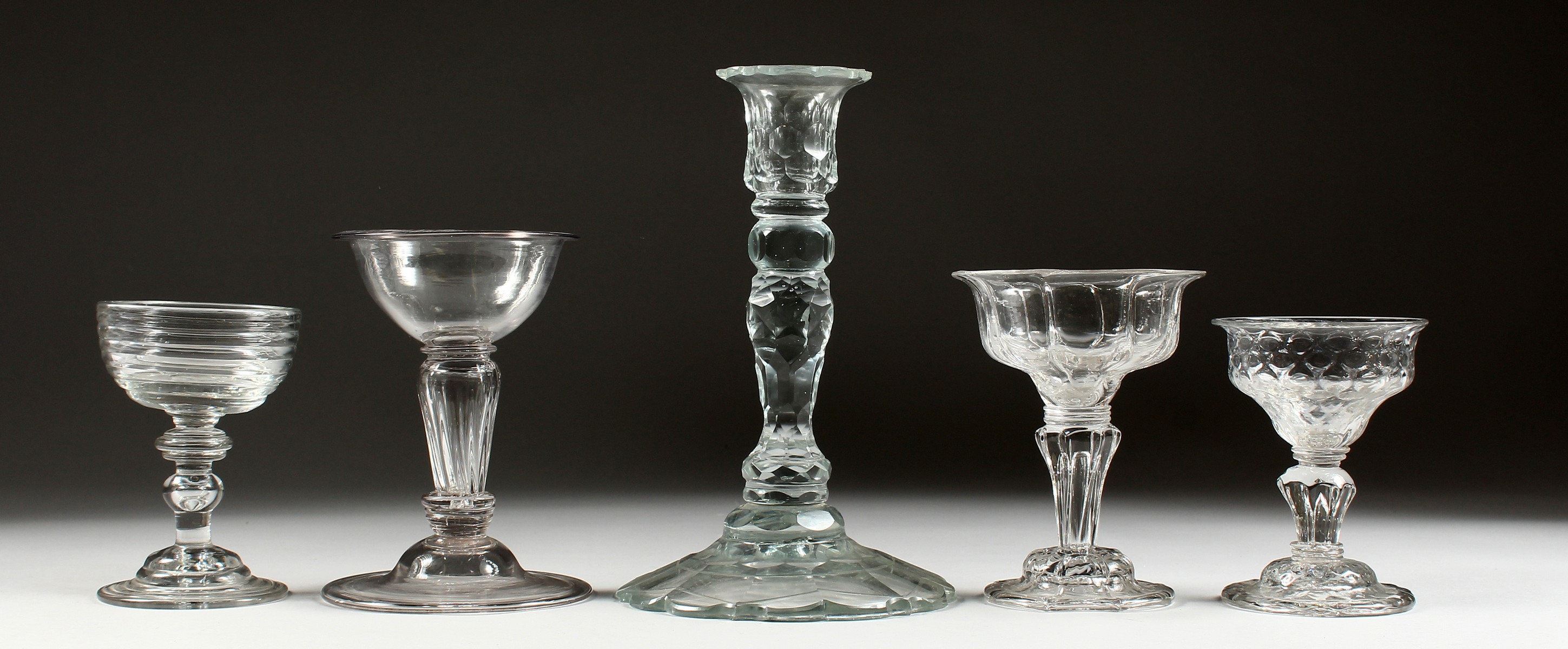 A GOOD 18TH/19TH CENTURY CUT GLASS CANDLESTICK; together with four 19th century cut and moulded