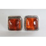 A LARGE PAIR OF SILVER AND AMBER EAR CLIPS.