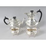 A FOUR PIECE SILVER TEA SET, comprising teapot, hot water jug, sugar basin and milk jug.