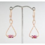 A PAIR OF 18CT ROSE GOLD DROP TWIST PINK SAPPHIRE (1.80cts) AND DIAMOND (0.49cts) EARRINGS.
