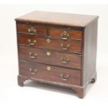 A GEORGE III MAHOGANY BACHELORS CHEST, with brushing slide, two short and three long graduated