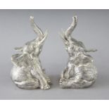 A PAIR OF CAST 800 SEATED ELEPHANT SALT AND PEPPERS. 3.25ins high.
