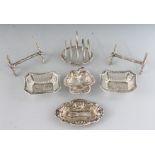A PAIR OF SILVER KNIFE RESTS, SMALL TOAST RACK AND THREE SMALL SILVER DISHES (6).
