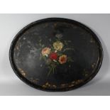 A VICTORIAN OVAL PAPIER MACHE TRAY, painted with a floral spray. 28.5ins wide.