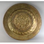 AN 18TH CENTURY BRASS CIRCULAR ALMS DISH repousse with a rosette. 16.5ins diameter.