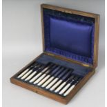 AN OAK CASE OF SIX SILVER AND MOTHER-OF-PEARL HANDLED FRUIT KNIVES. Sheffield 1919-1930. Maker: