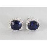 A SUPERB PAIR OF 18CT WHITE GOLD CUSHION SAPPHIRE, 4.51CTS, AND DIAMOND HALO EARRINGS, 0.26CTS.