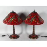 A GOOD PAIR OF TIFFANY DESIGN RED DRAGONFLY LAMPS. 22ins high.