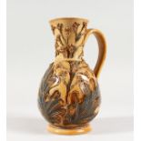 A DOULTON STONEWARE JUG by FRANK BUTLER, with leaves in relief. Maker F.A.B. 7.5ins high (AF).