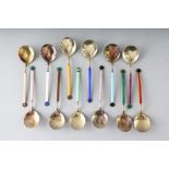 A SET OF TWELVE DAVID ANDERSON OF OSLO SILVER AND COLOURED ENAMEL SPOONS, cased.