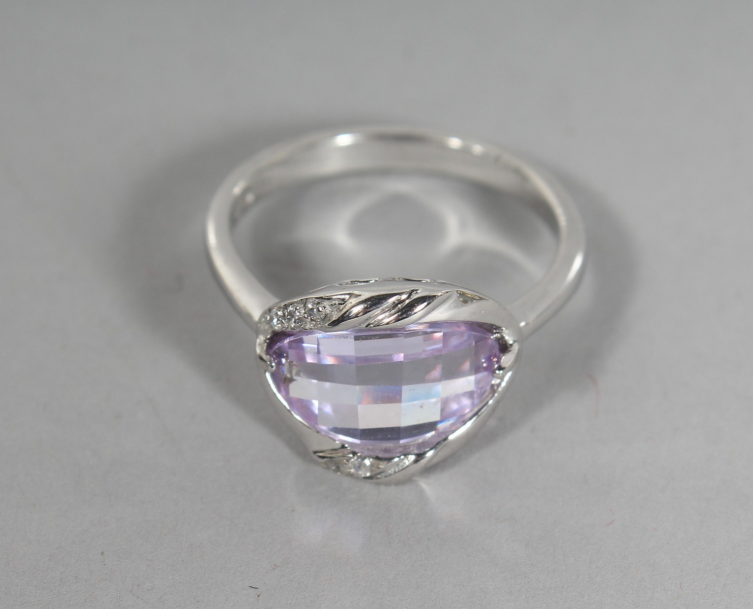 A SILVER CZ RING.