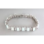 A GOOD SILVER, GILSON OPAL AND CZ LINE BRACELET.