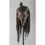 A CONWAY CARVED WOOD TRIBAL MASK with rope hair.