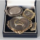 THREE VARIOUS VICTORIAN BROOCHES inset with hair and a silver locket (4).