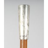 A GOOD RHINO HORN STICK with silver top, later engraved. 36ins long.