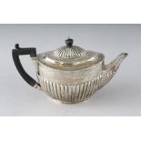A VICTORIAN OVAL HALF FLUTED TEAPOT with ebony handle. London 1893. Weight 15ozs.