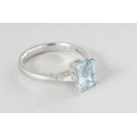 AN 18CT WHITE GOLD SINGLE STONE OCTAGON AQUAMARINE (1.21cts), with diamond (0.08cts) tapered