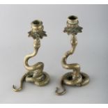 A PAIR OF BRASS SERPENT CANDLESTICKS. 8.5ins high.