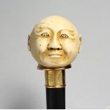 A GOOD WALKING CANE with carved ivory handle, head of a man, named on gilt band F. M. Camylon,