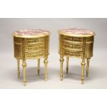 A GOOD PAIR OF THREE DRAWER GILT BEDSIDE TABLES with oval marble tops. 27ins high.