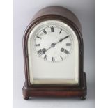 A 1930'S-1940'S MAHOGANY MANTLE CLOCK, with silvered dial on four bun feet. 11ins high.