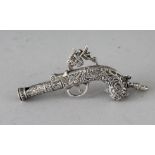 A NOVELTY SILVER GUN WHISTLE. 2.5ins.