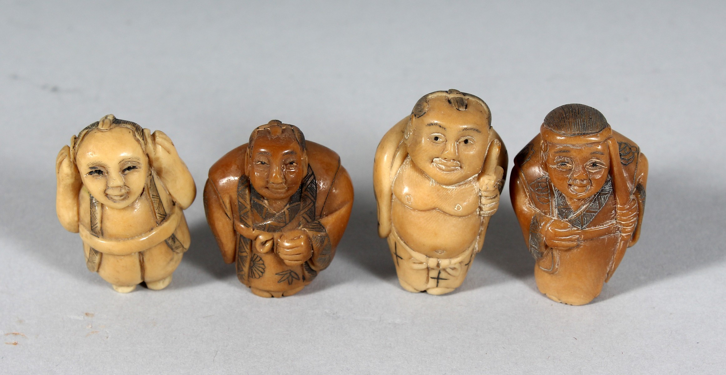 FOUR SMALL CARVED BONE NECKLACES.