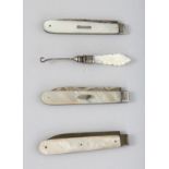 THREE SILVER AND MOTHER-OF-PEARL FRUIT KNIVES and a button hook.