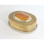 A BRASS OVAL SNUFF BOX with inset hardstone top. 2.75ins.