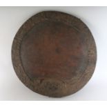 A 19TH CENTURY CARVED WOOD CIRCULAR PLATTER. 16ins diameter.