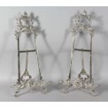 A GOOD LARGE PAIR OF SILVER EASELS. 20ins high.