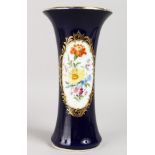A GOOD 19TH CENTURY MEISSEN RICH BLUE TRUMPET VASE, painted with an oval panel of flowers. Cross