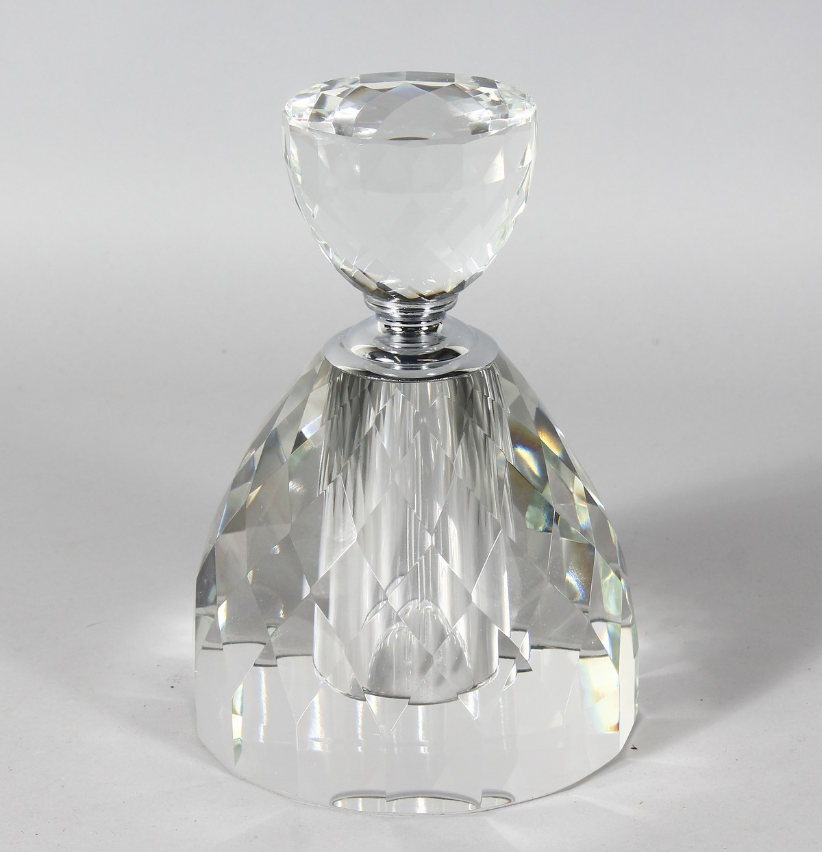A HEAVY FACET CUT CIRCULAR SCENT BOTTLE AND STOPPER. 9ins high.