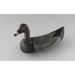 A CARVED WOOD AND PAINTED DECOY DUCK. 8ins long.