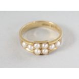 AN 18CT GOLD AND PEARL RING.