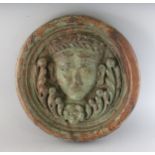 AN 18TH CENTURY CARVED WOOD ROUNDEL, carved with a head. 11.5ins diameter.