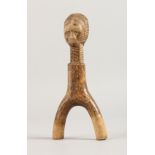 AN AFRICAN CARVED WOOD FIGURE. 8ins long.