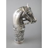 A WHITE METAL HORSES HEAD CANE HANDLE. 3.5ins.