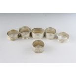 SIX VARIOUS SILVER SERVIETTE RINGS. Weight 4ozs.