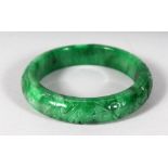 A CHINESE CARVED JADE BANGLE. 3ins diameter.