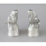 A PAIR OF CAST 800 HORSES HEAD SALT AND PEPPERS. 2.75ins high.