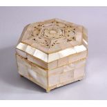 A 19TH CENTURY INDIAN MOTHER OF PEARL LIDDED BOX, the top with carved foliate design, 8cm wide.