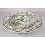 A LARGE CHINESE FAMILLE ROSE PORCELAIN BASIN, with panel decoration, of native floral decoration and