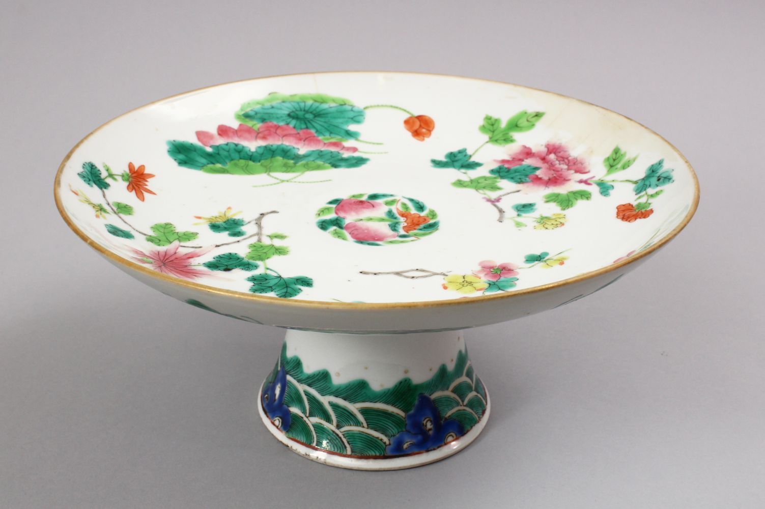 A 19TH CENTURY CHINESE FAMILLE ROSE PORCELAIN STEM DISH, decorated with native array of flora with a