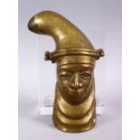A BRONZE CASE MASK OF A FIGURE, with a mediative expression, with a wall hanging to verso. 21cm.