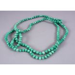 A CHINESE CARVED APPLE GREEN JADE LIKE NECKLACE, 118cm approx. open.