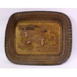 AN EARLY 20TH CENTURY JAPANESE MIXED METAL TRAY, etched with a landscape and temples with figural