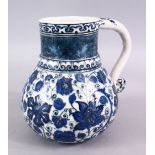 AN ISLAMIC BLUE & WHITE PORCELAIN WATER JUG, decorated ith formal scrolling flora, 20cm high.