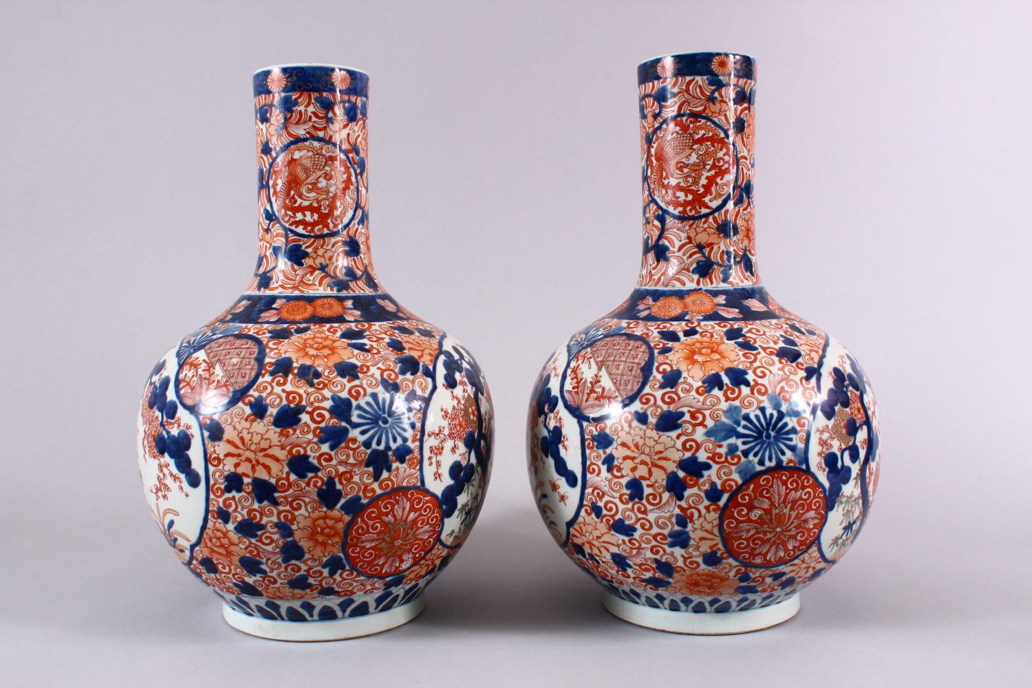 A PAIR OF JAPANESE MEIJI PERIOD IMARI PORCELAIN BOTTLE VASES, decorated with panels of the three - Image 2 of 6